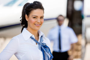 Stewardesses Smiling With Pilot And Private Jet In