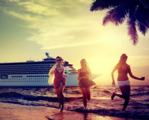 happy people running on the beach near a cruise ship